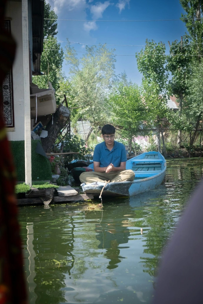 A man sitting on a boat in a body of water